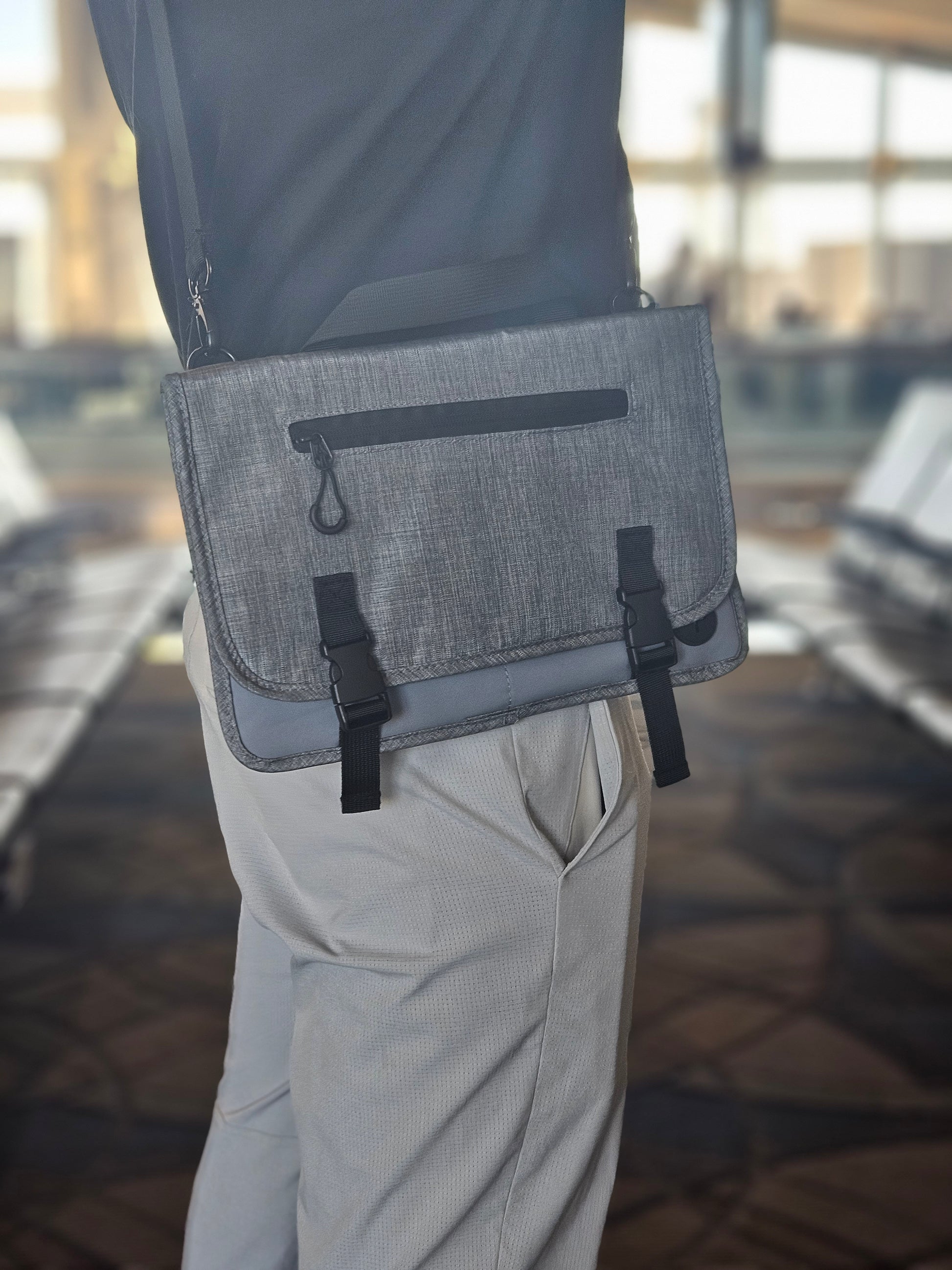 Man wearing Jet Pocket with removeable shoulder strap in airport as crossbody with buckle closure