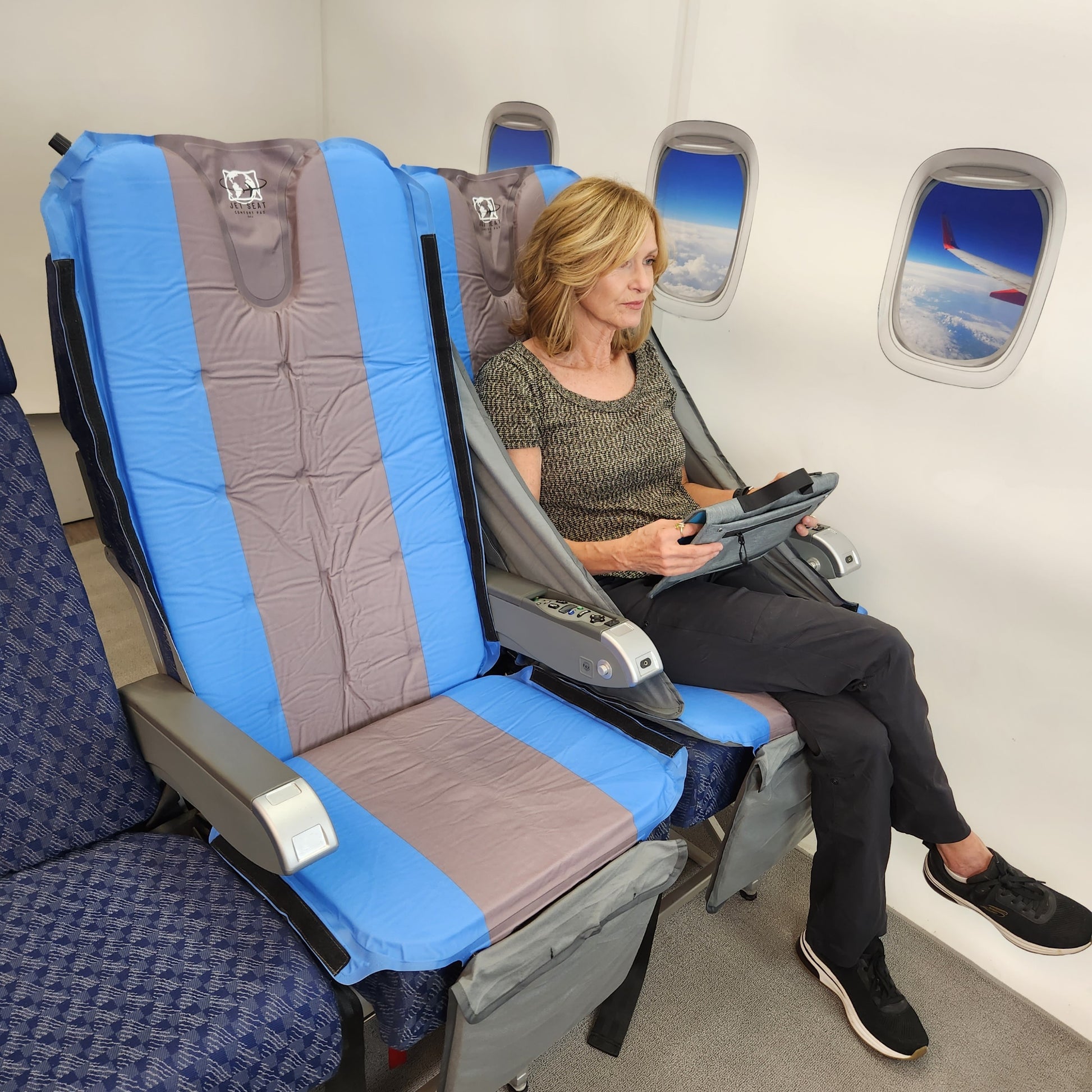 Woman sitting in Jet Seat enjoying comfort and relief from back pain on airplane during travel