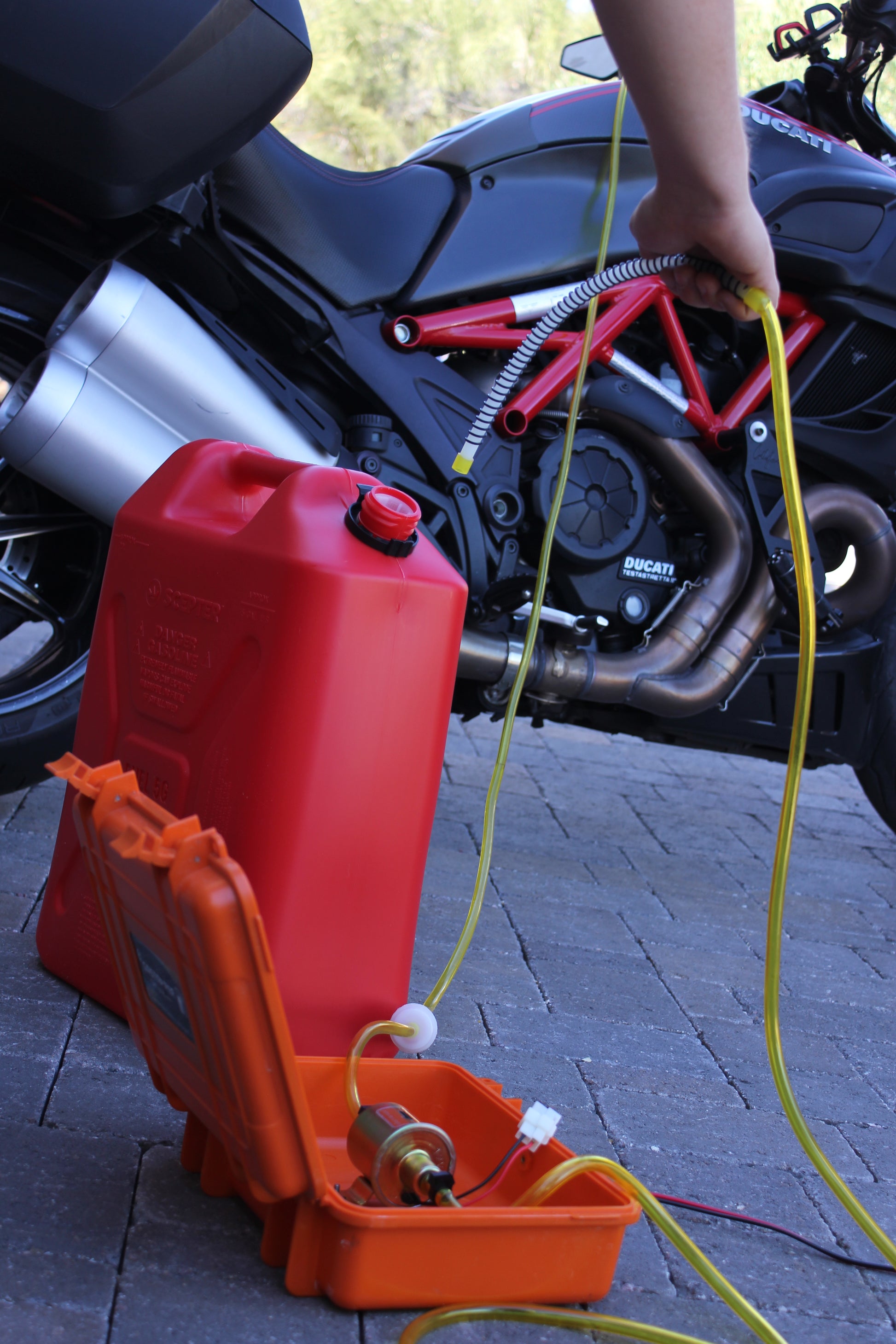 12-volt transfer system being used to move gasoline from motorcycle tank into gas can
