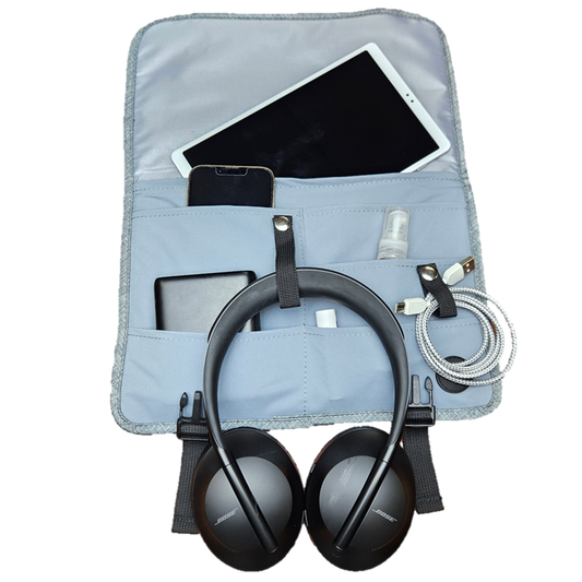 Gray jet pocket holding kindle, cell phone, headphones, charging cord, portable battery, great for easy access on airplane