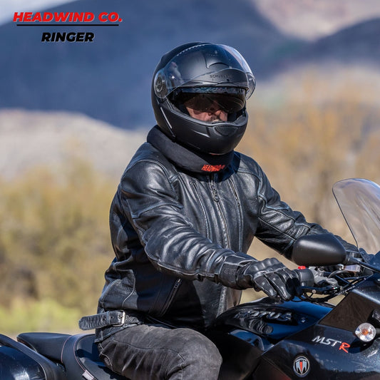 Headwind Ringer being worn around man's neck riding motorcycle with helmet, enjoying the warmth of a neck ring